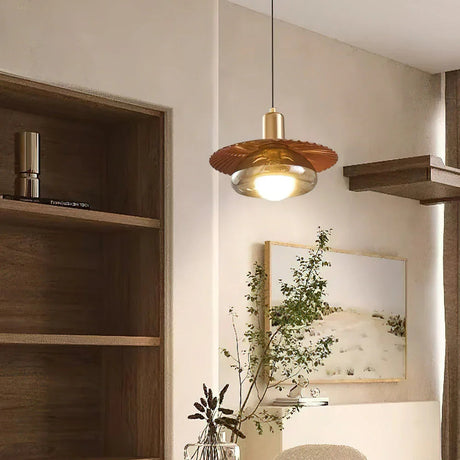 The walnut grain disc lit beside open shelves and a trailing plant