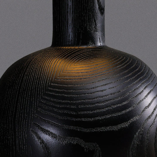 Close view of the grain on the black wood sphere