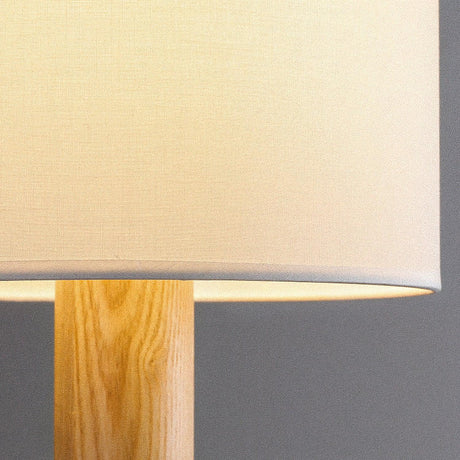 Close view of the fabric drum meeting the slim wood stem