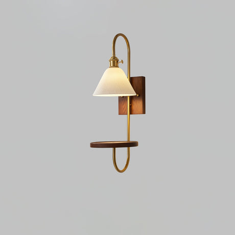 White shade above a walnut shelf carried on a slim brass loop
