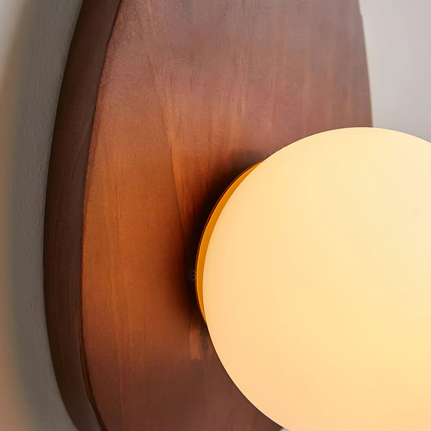 Close view of the walnut grain running across the plate beside the globe