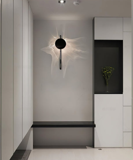 The single disc light lit in an entry above a bench and a niche