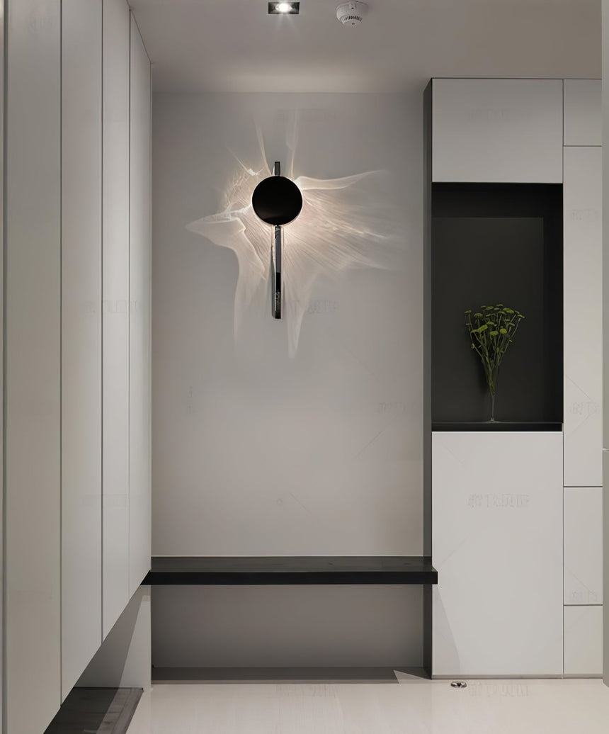 The single disc light lit in an entry above a bench and a niche
