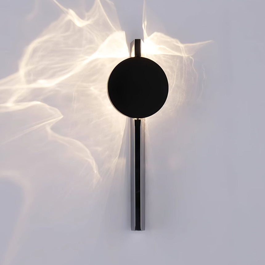 The disc lit, waves of light spreading across the wall