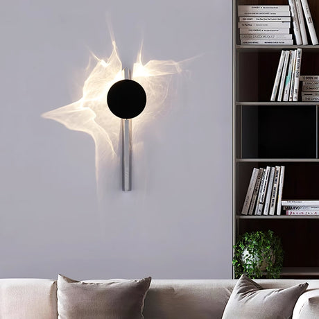 The single disc light lit above a sofa beside a bookshelf