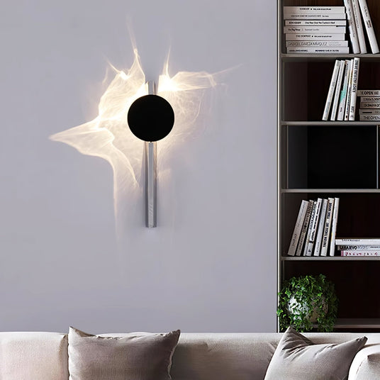 The single disc light lit above a sofa beside a bookshelf