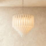 The small version lit warm, its frosted tubes stepping down in five rows