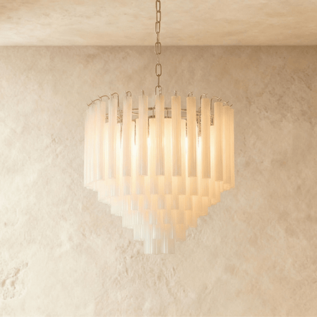 The small version lit warm, its frosted tubes stepping down in five rows