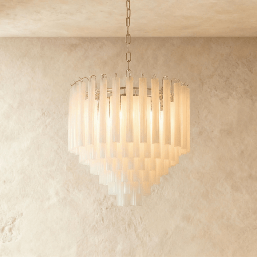 The small version lit warm, its frosted tubes stepping down in five rows