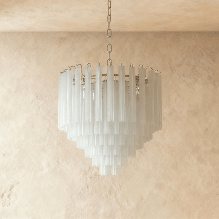 The frosted glass tubes switched off, reading white against a pale ceiling