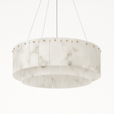 The same drum of alabaster panels unlit, bolts showing along the top band
