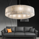 The lit drum in a living room with a gray sofa and a slatted wall