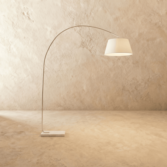 A tall curved arm carrying a white fabric drum shade above a pale stone base