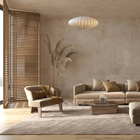 Silk saucer shade lit in a calm interior with wood furniture