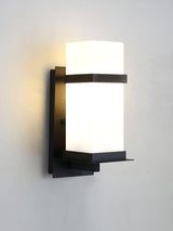 The light lit on a gray wall, the glow even across the frosted glass