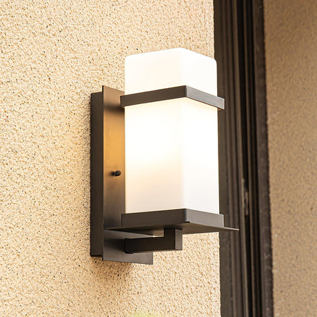 The light on sand colored render beside a dark door frame