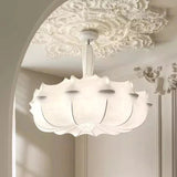 Layered silk pendant seen from below against a molded ceiling