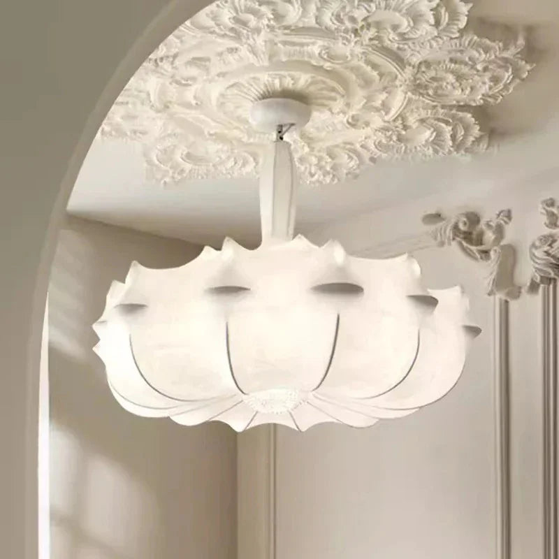 Layered silk pendant seen from below against a molded ceiling