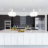 Pair of layered silk pendants above a dark kitchen island