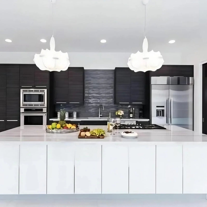 Pair of layered silk pendants above a dark kitchen island