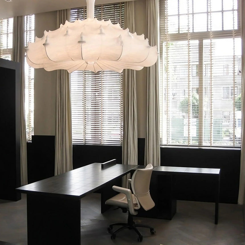 Layered silk pendant in a lounge with armchairs below it