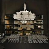 Row of layered silk pendants above a long table