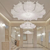 Layered silk pendant in a white room with a glass table