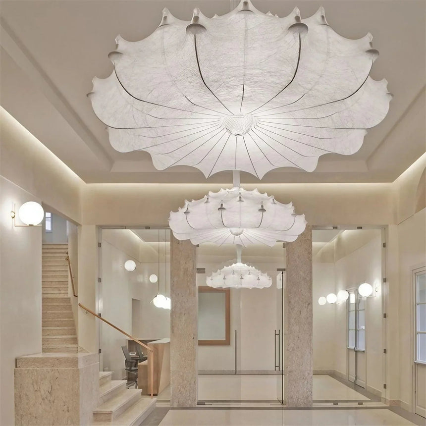 Layered silk pendant in a white room with a glass table