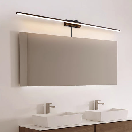 Dark bar lit above a wide mirror over two basins, the cord running down to an outlet