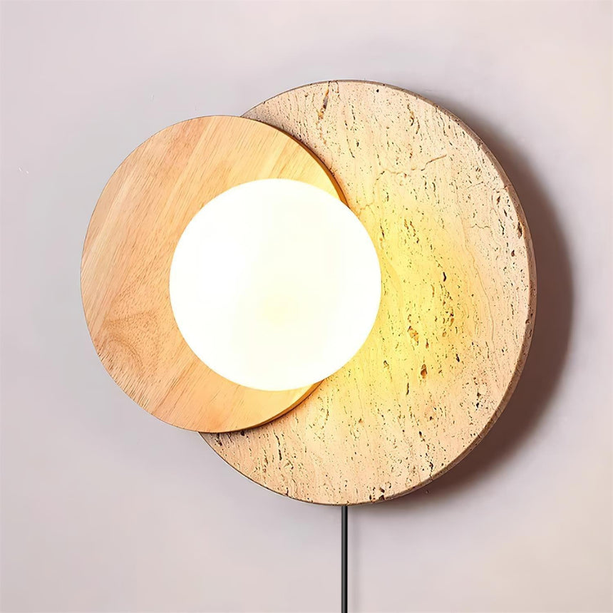 The white glass orb lit bright between two overlapping discs