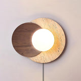 Walnut disc version lit warm, the white orb glowing at the overlap