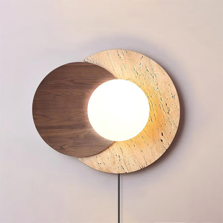 Walnut disc version lit warm, the white orb glowing at the overlap