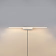 The white version lit on a pale wall, the cord hanging below the offset block