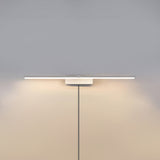 The white version lit on a pale wall, the cord hanging below the offset block