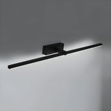 The black bar lit on a gray wall, the diffuser bright along its underside