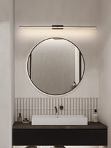 Bar lit above a round mirror over a stone basin on a dark timber vanity