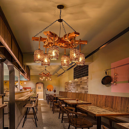 Two of them lit along a counter with bar stools and wood tables in a long room