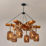 The six woven shades lit against a soft gray wall, hanging under the crossed timber beams