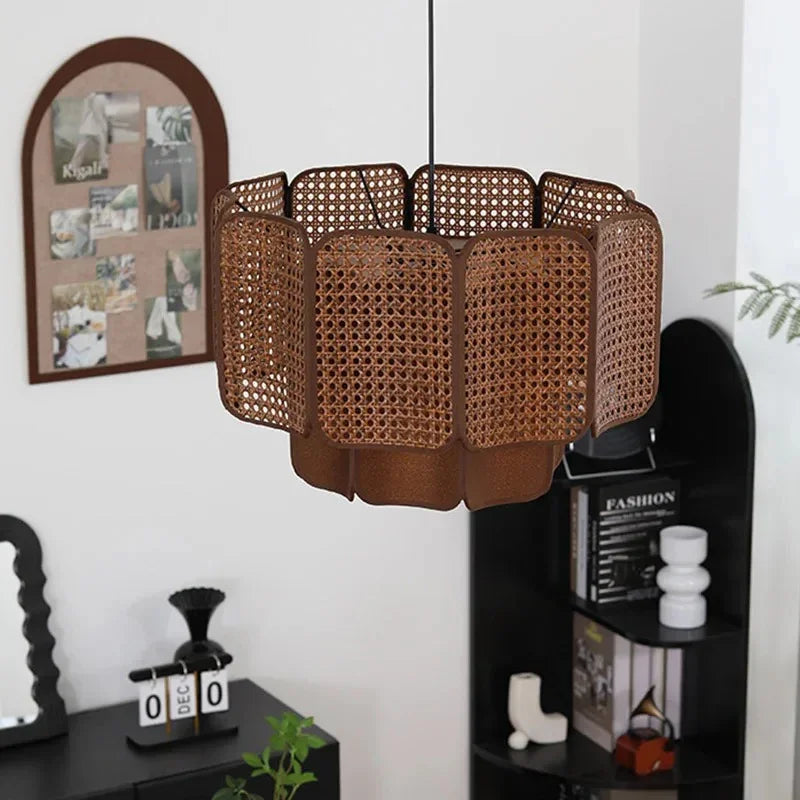 Wicker hanging lamp in a hallway beside framed pictures