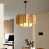 Wicker hanging lamp lit in a living room with a television