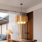 Natural wicker hanging lamp beside a curtained window
