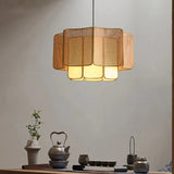 Wicker hanging lamp above a sideboard with vases