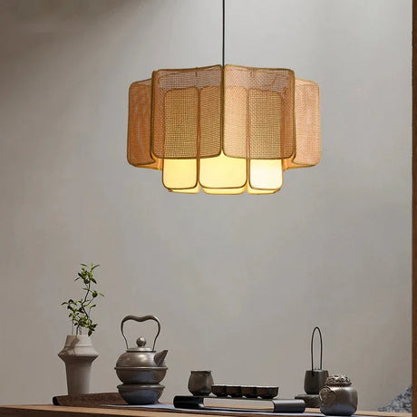 Wicker hanging lamp above a sideboard with vases