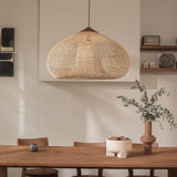 Wicker dome hung against a pale plaster wall