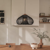 Wicker dome above a shelf with ceramics and a plant