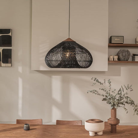 Wicker dome above a shelf with ceramics and a plant