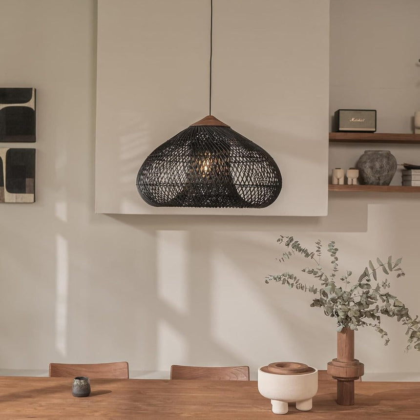 Wicker dome above a shelf with ceramics and a plant