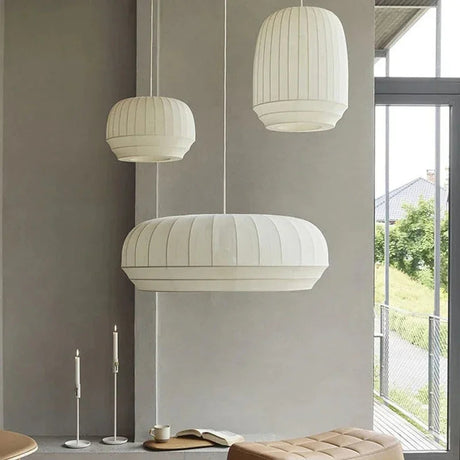 Tall and wide knitted shades hung together in a pale room