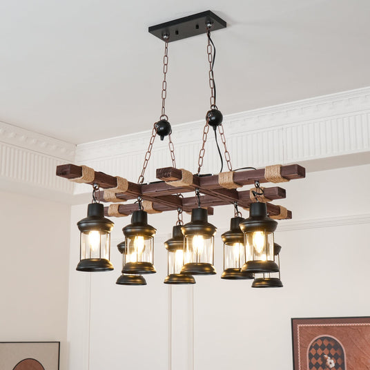 Lit in a paneled room above framed artwork, the eight lanterns glowing amber