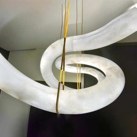 The alabaster ribbon at the point where the brass cables meet the stone